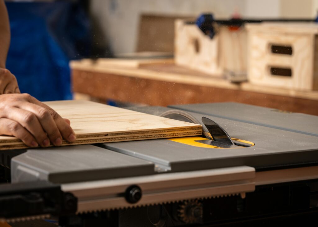 Craftsman working with a circular saw, expertly cutting plywood for woodworking projects.